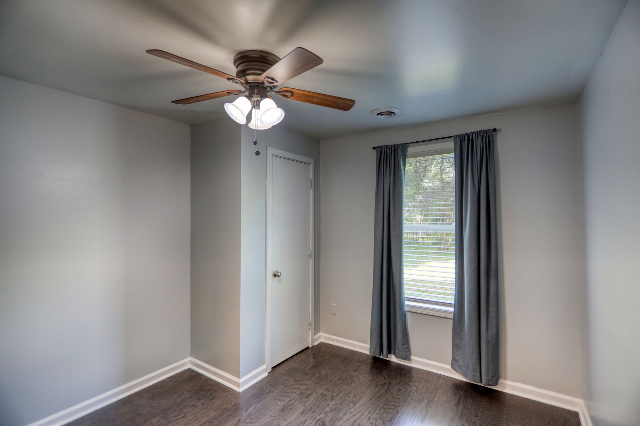 812 Butler Road Portland, TN 37148 - Photo 8 of 13 an empty room with wooden floor fan and windows