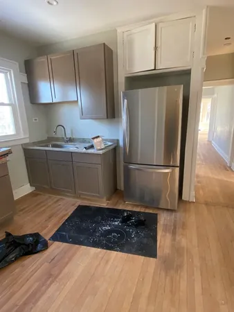 a kitchen with stainless steel appliances granite countertop a refrigerator a stove and a sink