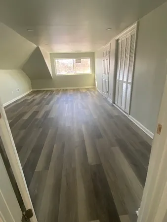 a view of an empty room and wooden floor