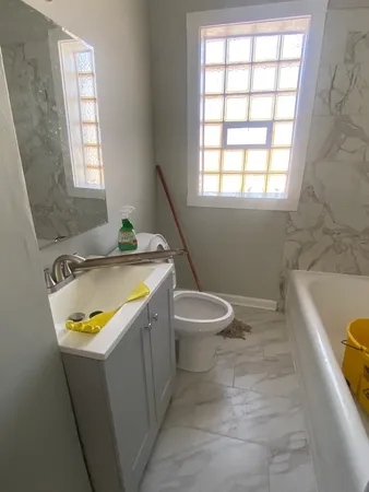 a bathroom with a sink a toilet and bathtub