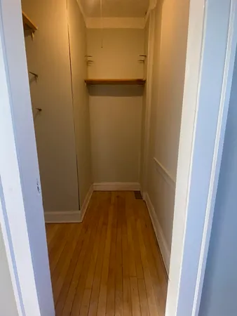 a view of a room with wooden floor