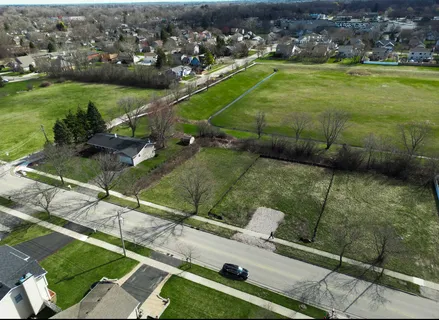 an aerial view of a houses with a yard