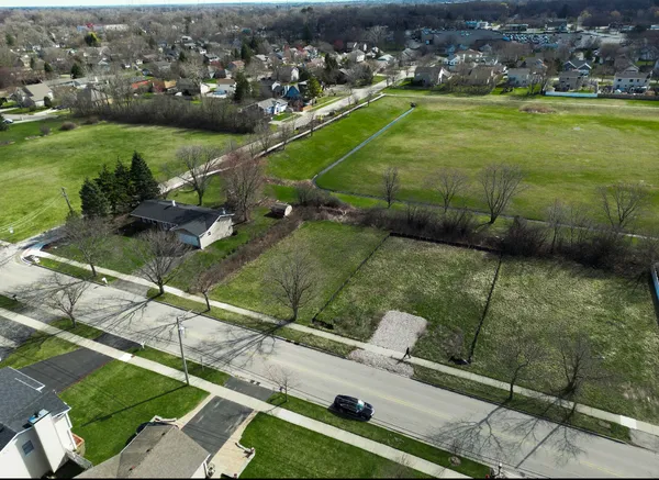 an aerial view of a houses with a yard