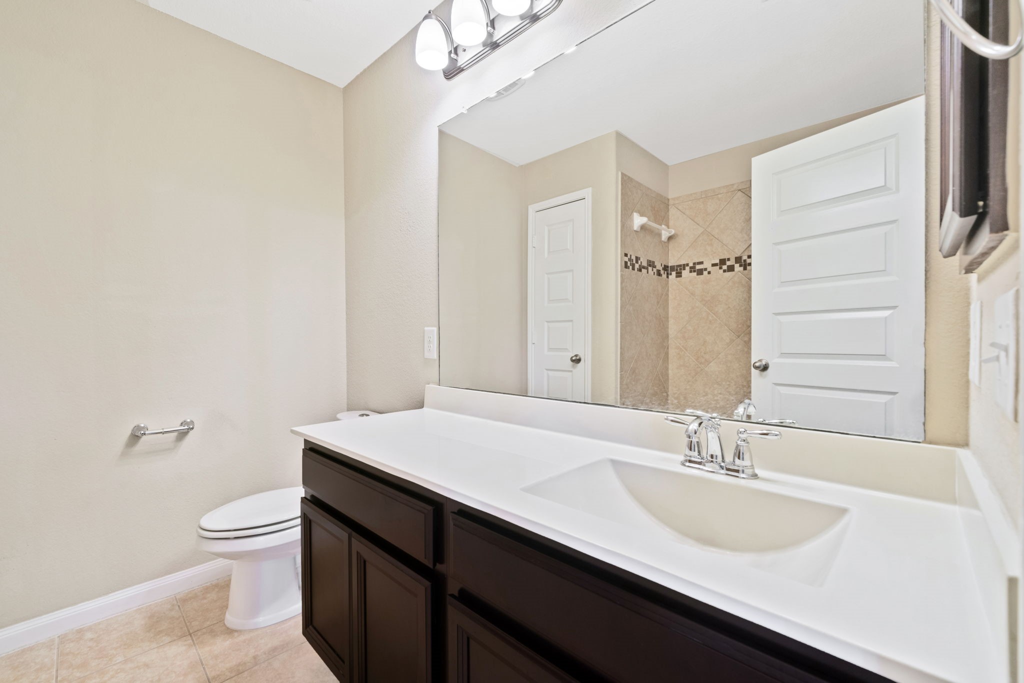 22523 Birch Ridge Meadow Drive Spring, TX 77389 - Photo 31 of 39 a bathroom with a sink a toilet a mirror and vanity