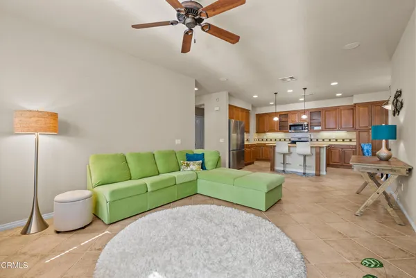 a living room with furniture and kitchen view