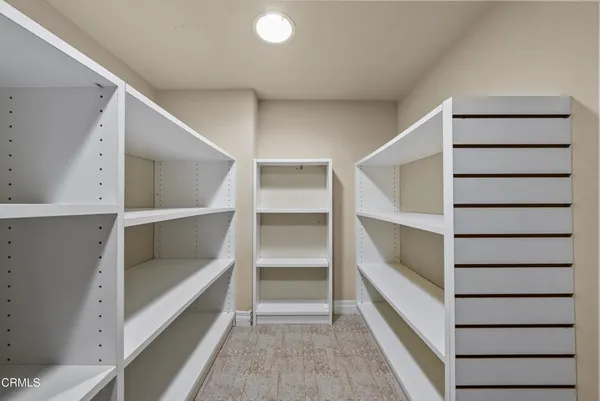 a view of walk in closet with empty racks