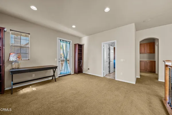 a view of an empty room with window and furniture