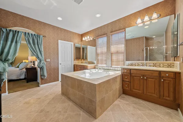 a spacious bathroom with a granite countertop sink a toilet and shower