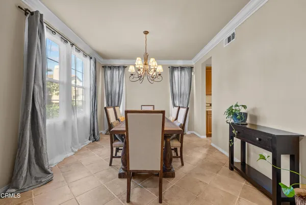 a view of a dining room with furniture and a window