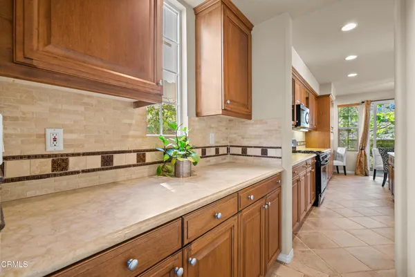 a kitchen with stainless steel appliances granite countertop a sink and a stove