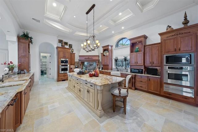 a large kitchen with stainless steel appliances granite countertop a stove oven and a refrigerator