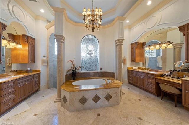 a large spacious bathroom with a large tub and sink