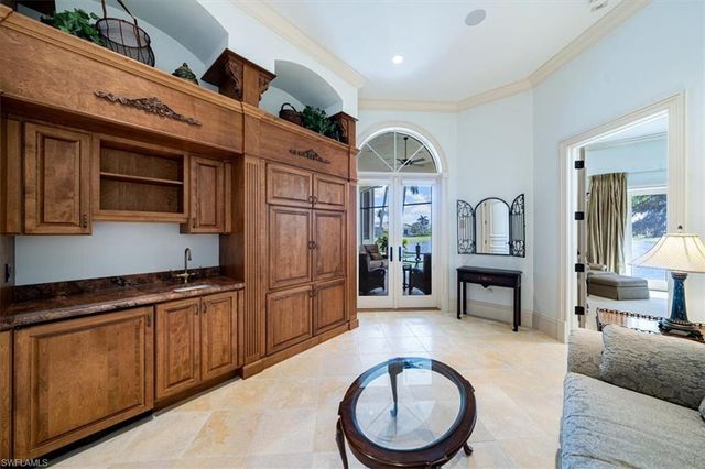 a view of living room kitchen with stainless steel appliances granite countertop room washer and dryer