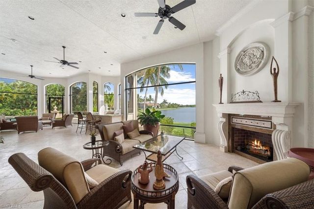 a living room with furniture a large window and a fireplace
