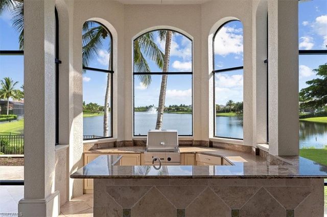 a living room filled with furniture and a floor to ceiling window