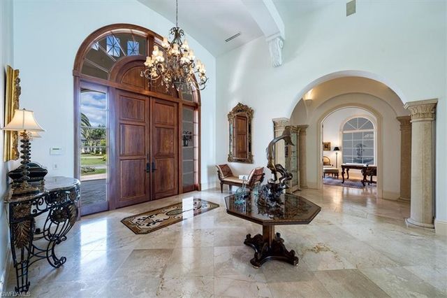 a living room with furniture a fireplace and gym equipment