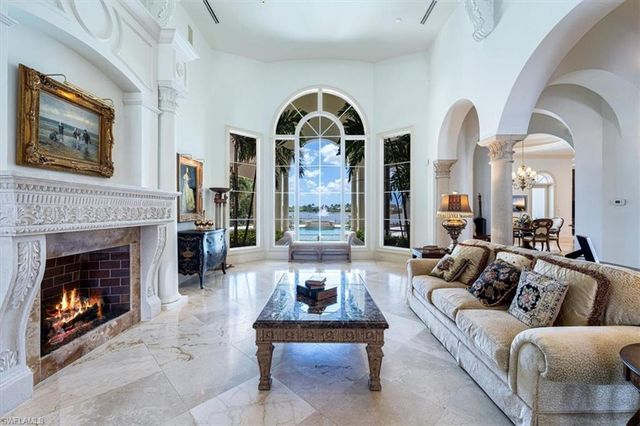 a living room with furniture fireplace and window