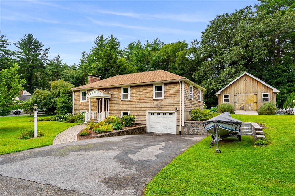 a front view of house with yard and green space