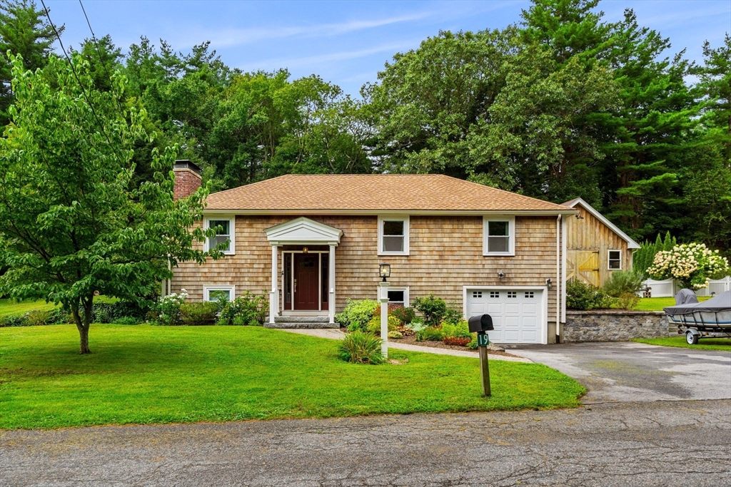 19 Forrest Road Topsfield, MA 01983 - Photo 2 of 39 a front view of a house with a garden and trees