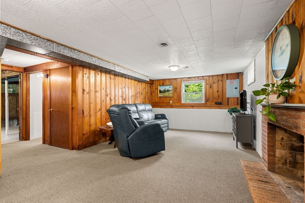 19 Forrest Road Topsfield, MA 01983 - Photo 25 of 39 a living room with furniture a fireplace and a window