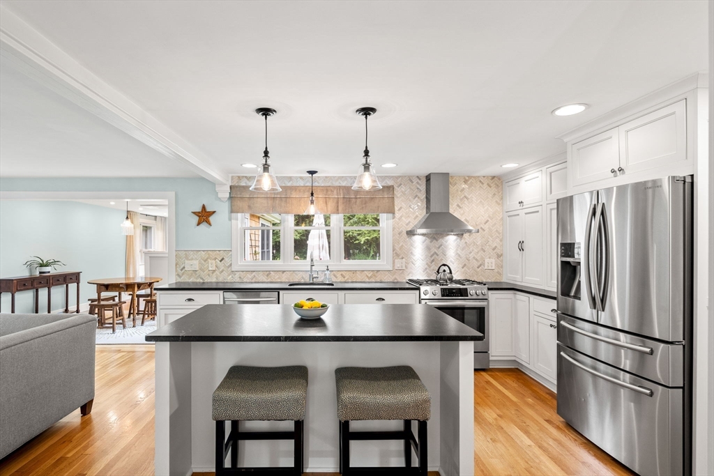 19 Forrest Road Topsfield, MA 01983 - Photo 3 of 39 a kitchen with kitchen island a counter top space a sink appliances and cabinets