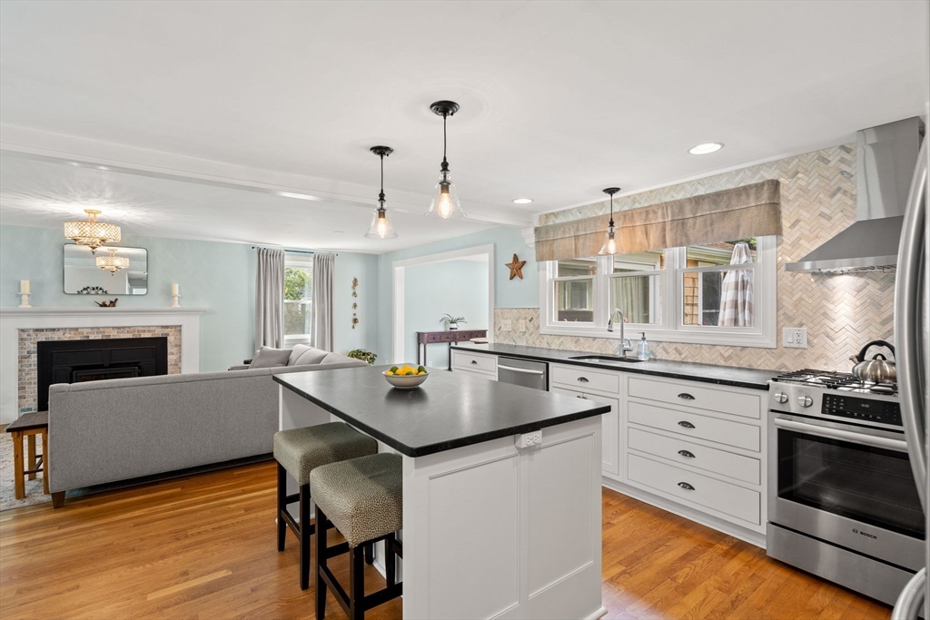 19 Forrest Road Topsfield, MA 01983 - Photo 8 of 39 a kitchen with stainless steel appliances granite countertop a stove a sink dishwasher and a refrigerator with wooden floor