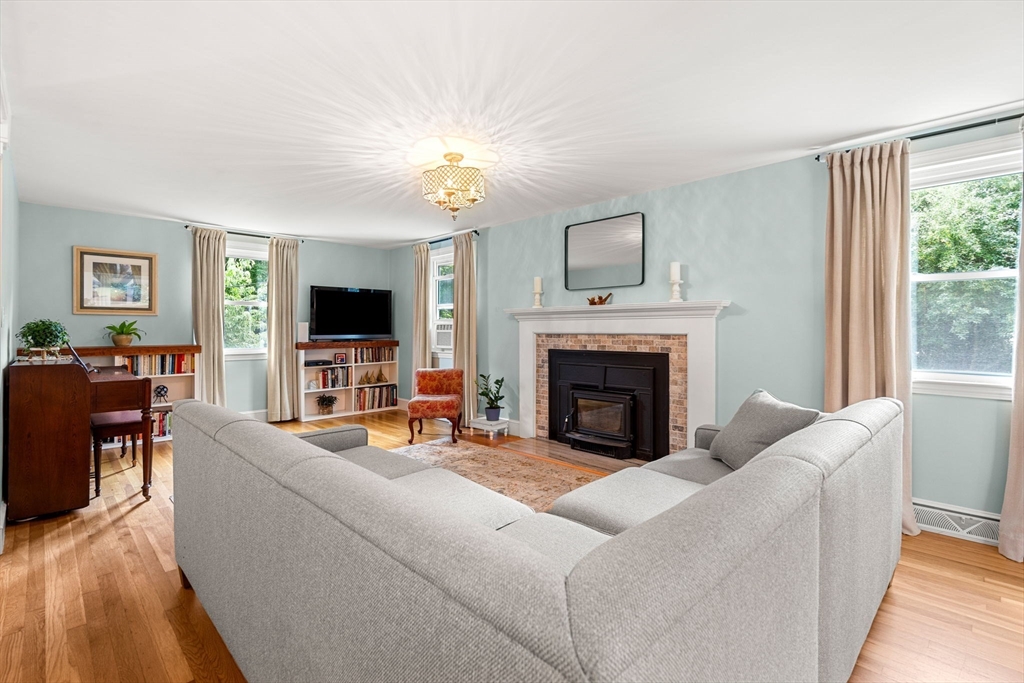 19 Forrest Road Topsfield, MA 01983 - Photo 9 of 39 a living room with furniture flat screen tv and a fireplace