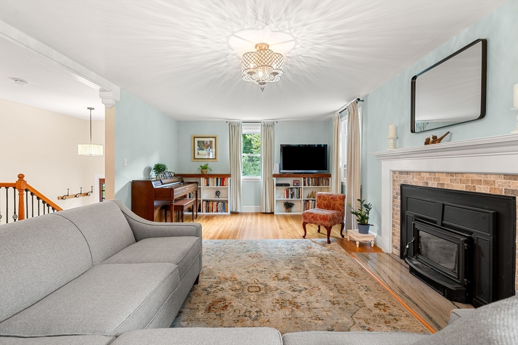 19 Forrest Road Topsfield, MA 01983 - Photo 10 of 39 a living room with furniture a fireplace and a flat screen tv