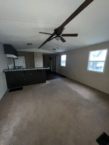 a view of a livingroom with furniture and windows