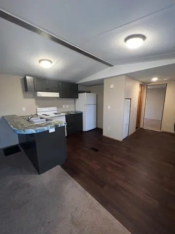 a kitchen with a sink and wooden cabinets
