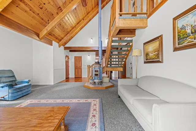 a living room with furniture a rug and a large window