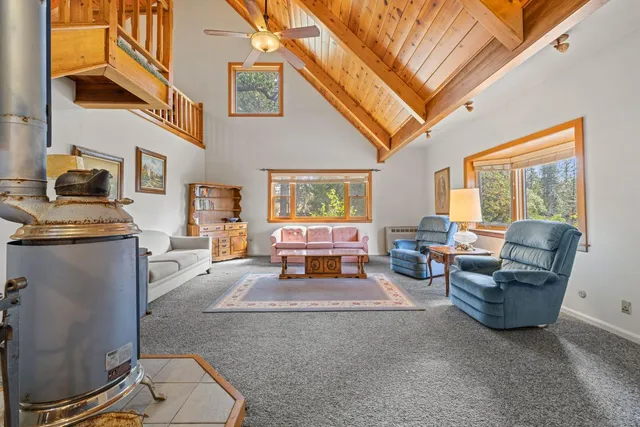 a dining hall with stainless steel appliances wooden floors a dining table and chairs with wooden floor