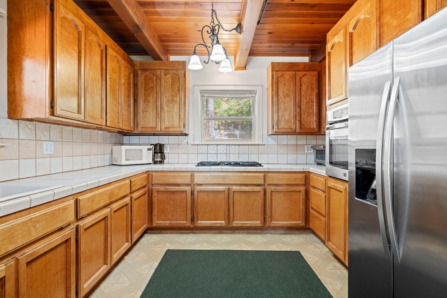8061 Happy Valley Road Somerset, CA 95684 - Photo 20 of 66 a kitchen with stainless steel appliances granite countertop a sink a stove and a refrigerator
