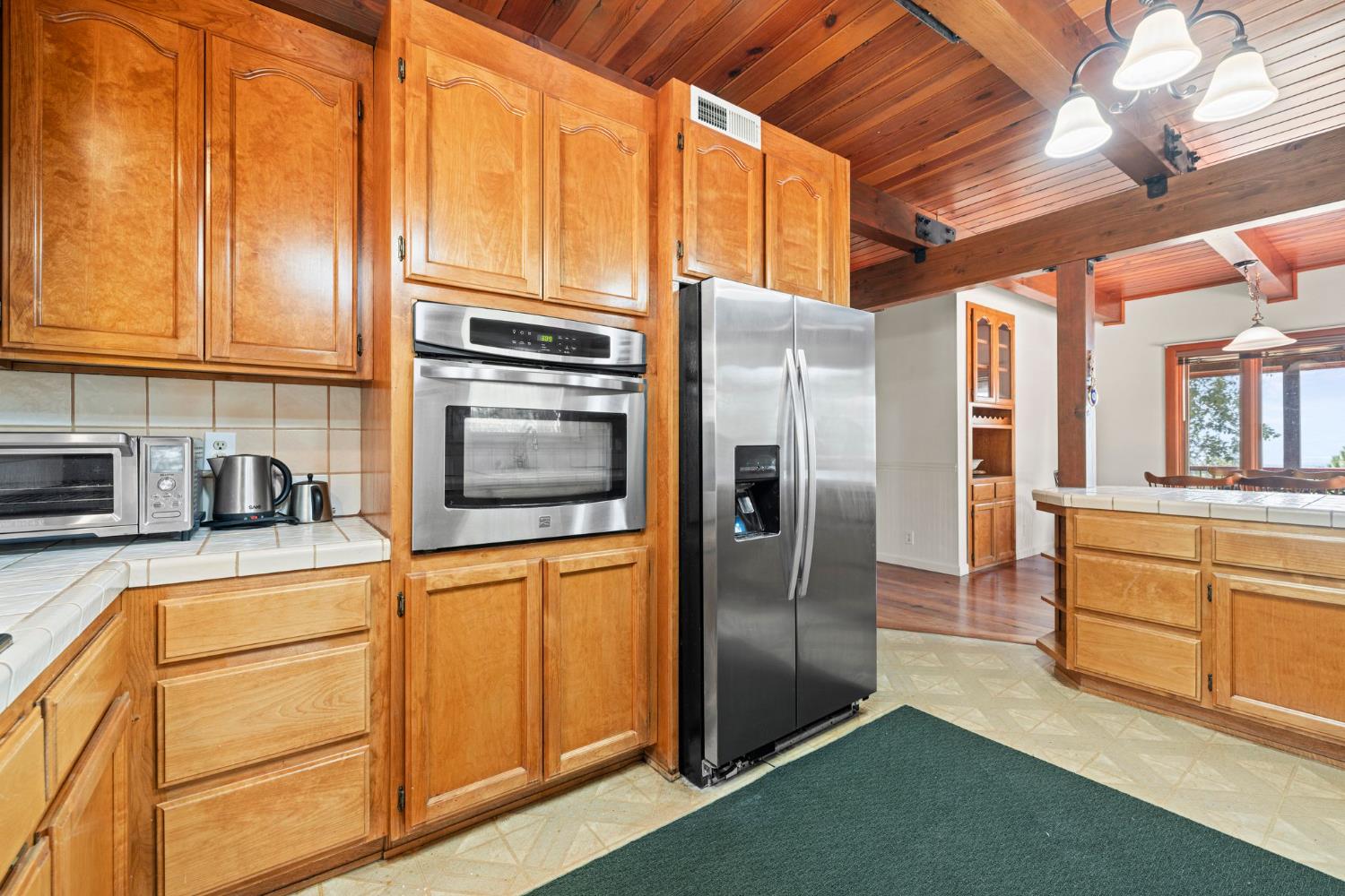 8061 Happy Valley Road Somerset, CA 95684 - Photo 21 of 66 a kitchen with stainless steel appliances granite countertop a refrigerator a stove and a sink with large cabinets