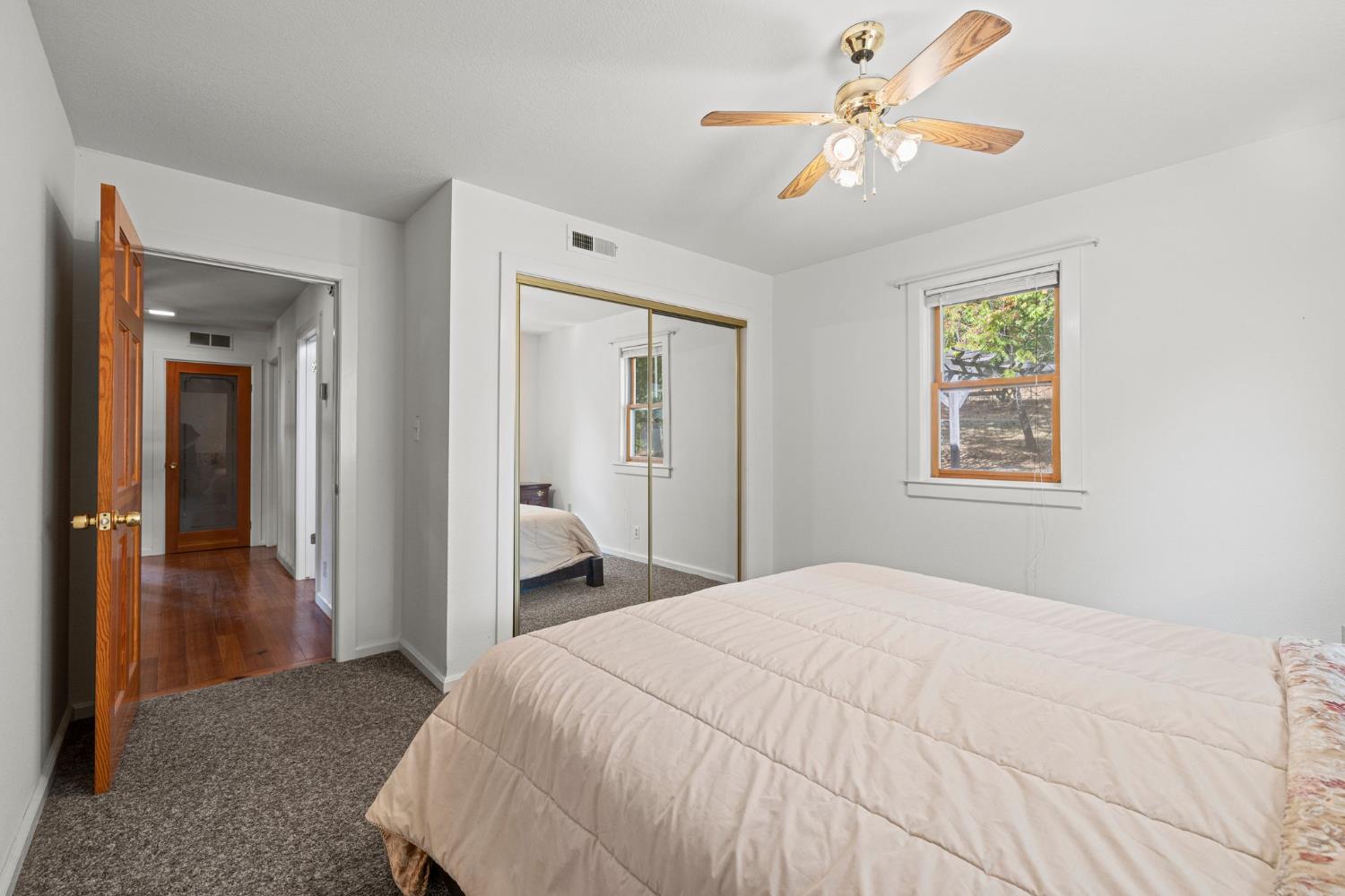 8061 Happy Valley Road Somerset, CA 95684 - Photo 27 of 66 a bedroom with a bed and a chandelier