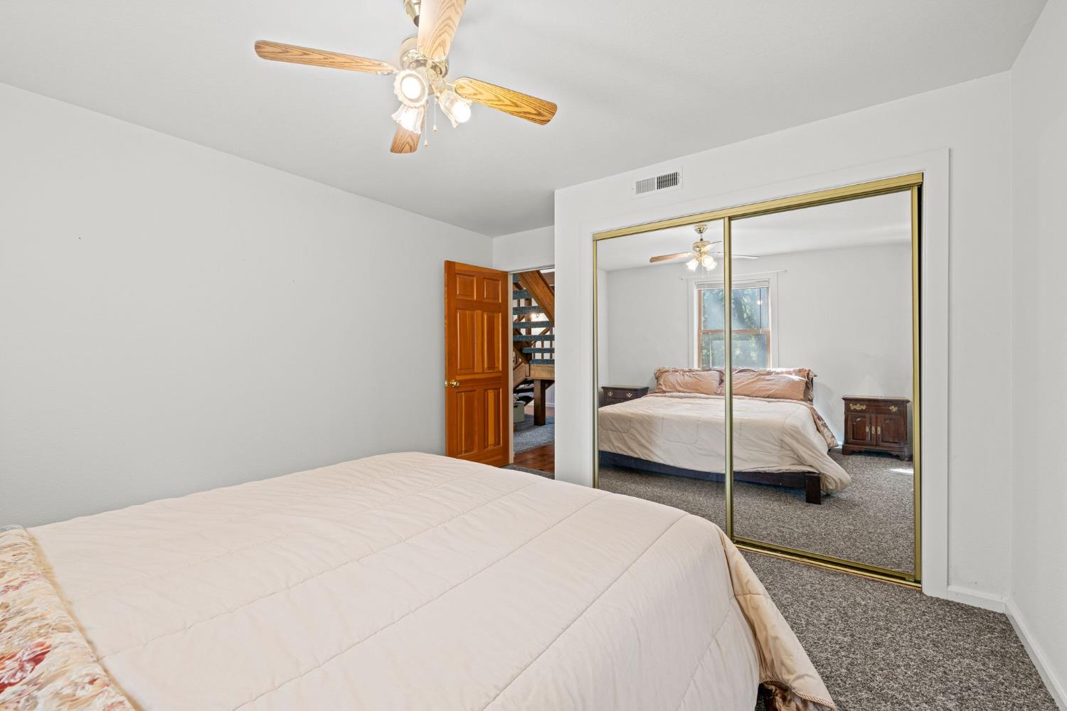 8061 Happy Valley Road Somerset, CA 95684 - Photo 28 of 66 a bedroom with a bed and a chandelier