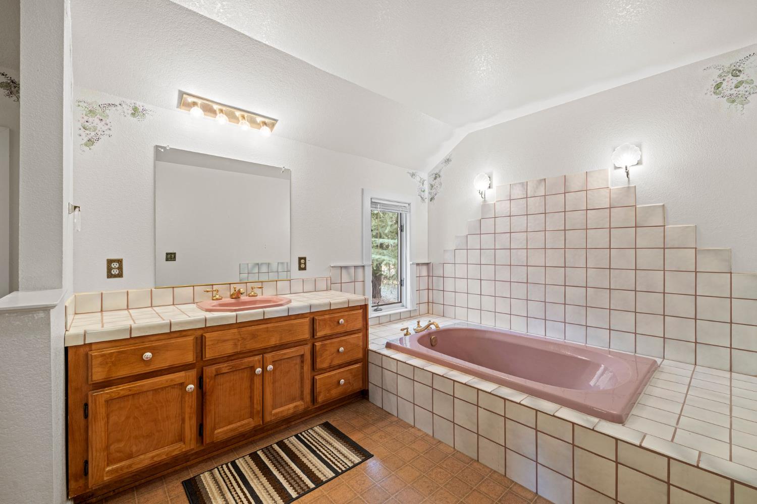 8061 Happy Valley Road Somerset, CA 95684 - Photo 34 of 66 a bathroom with a tub a sink a mirror and a shower