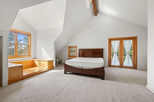 a white house that has a tree in front of it