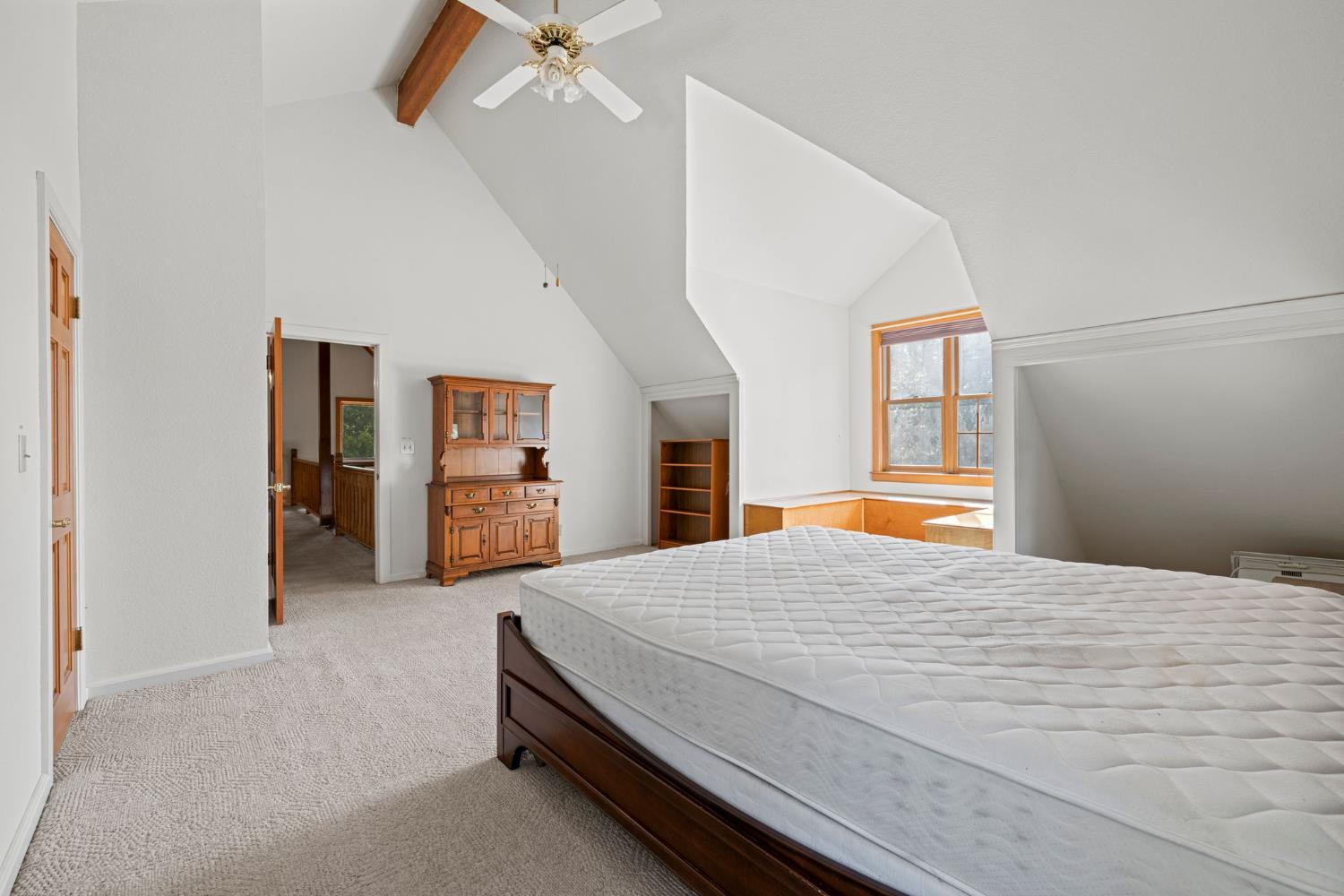 8061 Happy Valley Road Somerset, CA 95684 - Photo 39 of 66 a bedroom with a bed and a chandelier