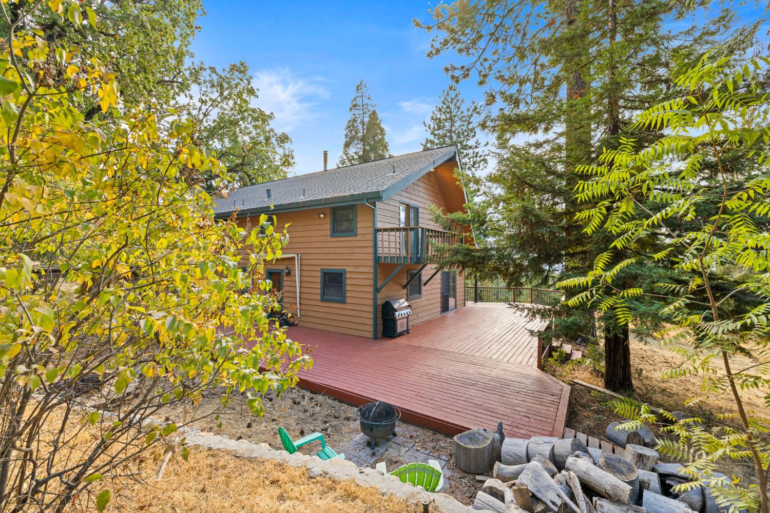 8061 Happy Valley Road Somerset, CA 95684 - Photo 41 of 66 a yellow house with trees in front of it