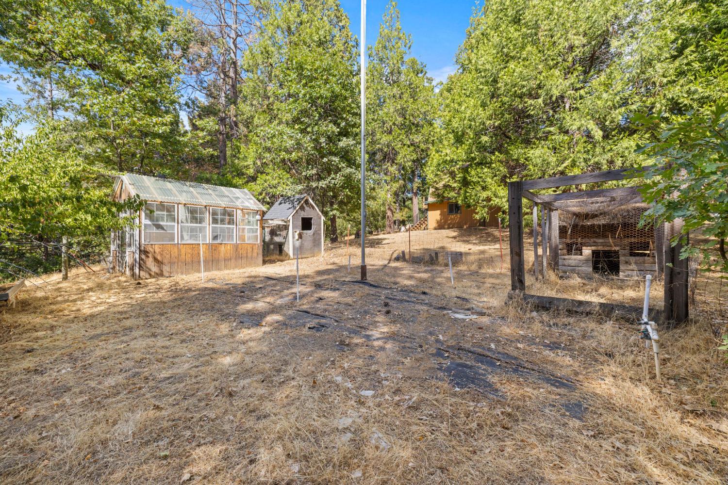 8061 Happy Valley Road Somerset, CA 95684 - Photo 44 of 66 a backyard of a house with table and chairs