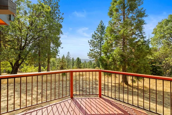 a spacious bedroom with a bed and a chandelier