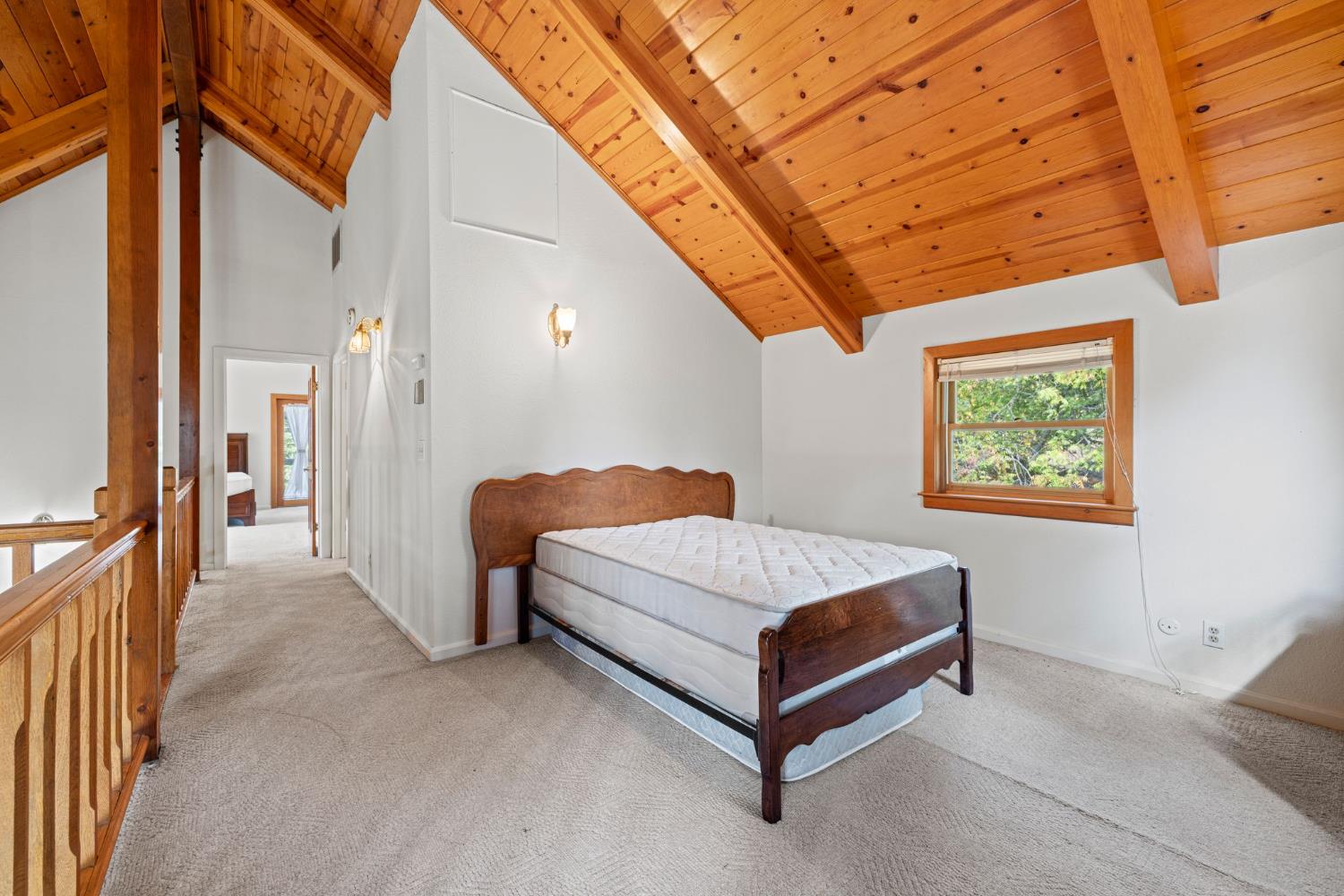 8061 Happy Valley Road Somerset, CA 95684 - Photo 7 of 66 a spacious bedroom with a bed and a chandelier