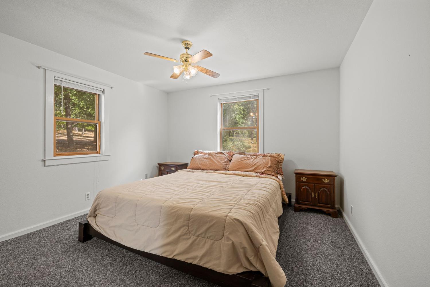 8061 Happy Valley Road Somerset, CA 95684 - Photo 9 of 66 a bedroom with a bed and a chandelier