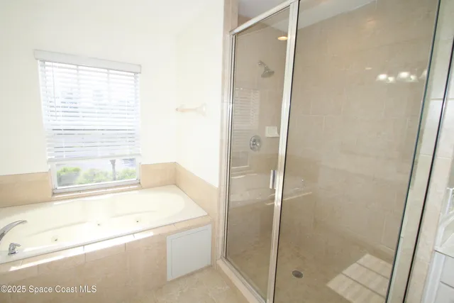 a bathroom with a tub and a shower