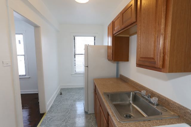 4608 North Beacon Street, Unit 3C Chicago, IL 60640 - Photo 4 of 12 a kitchen with a sink and a refrigerator