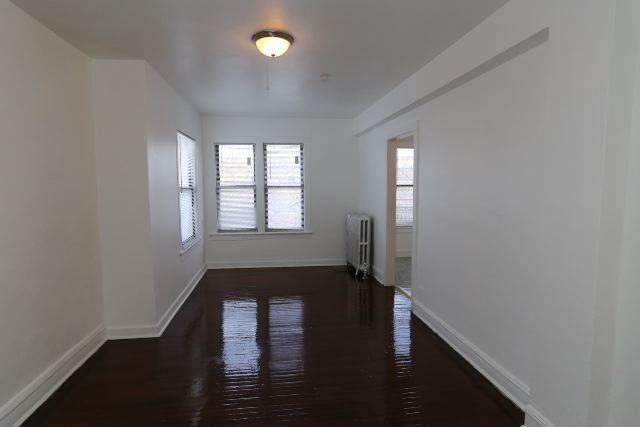 4608 North Beacon Street, Unit 3C Chicago, IL 60640 - Photo 9 of 12 wooden floor in an empty room with a window