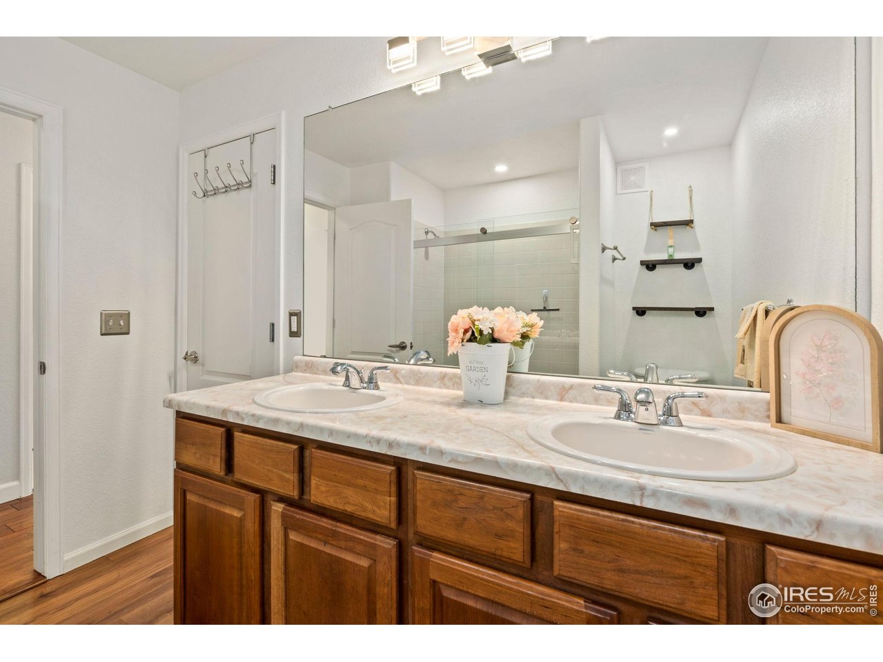 5014 Brookfield Drive, Unit B Fort Collins, CO 80528 - Photo 13 of 18 Dual vanity in shared primary bathroom with updated fixtures