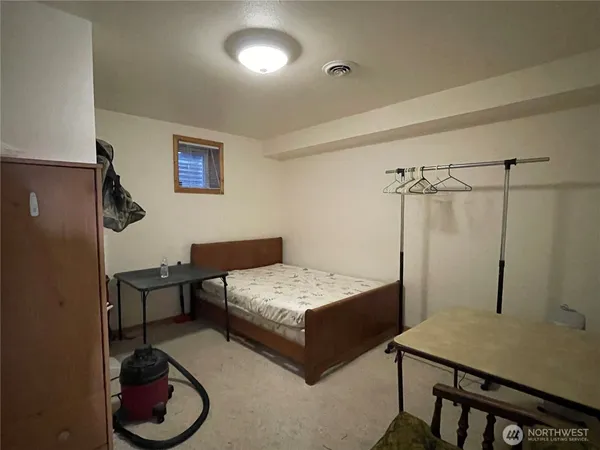 a bedroom with a bed and a table in it