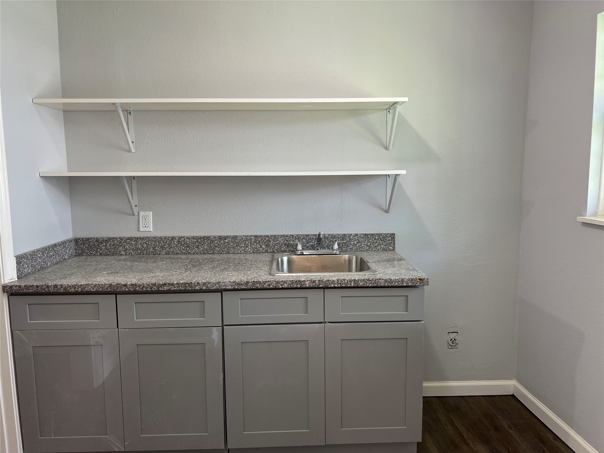 6823 Ave East Houston, TX 77011 - Photo 16 of 16 a utility room with granite countertop cabinets and a sink
